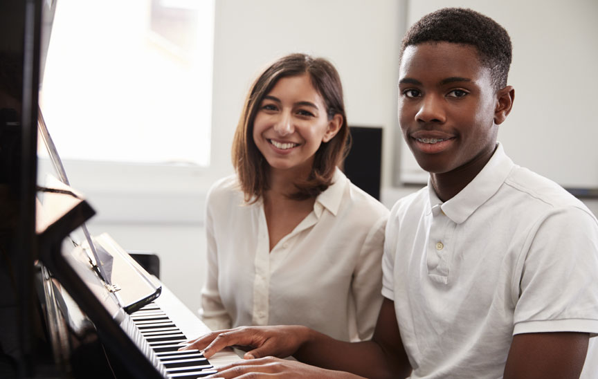 Boy with teacher at piano